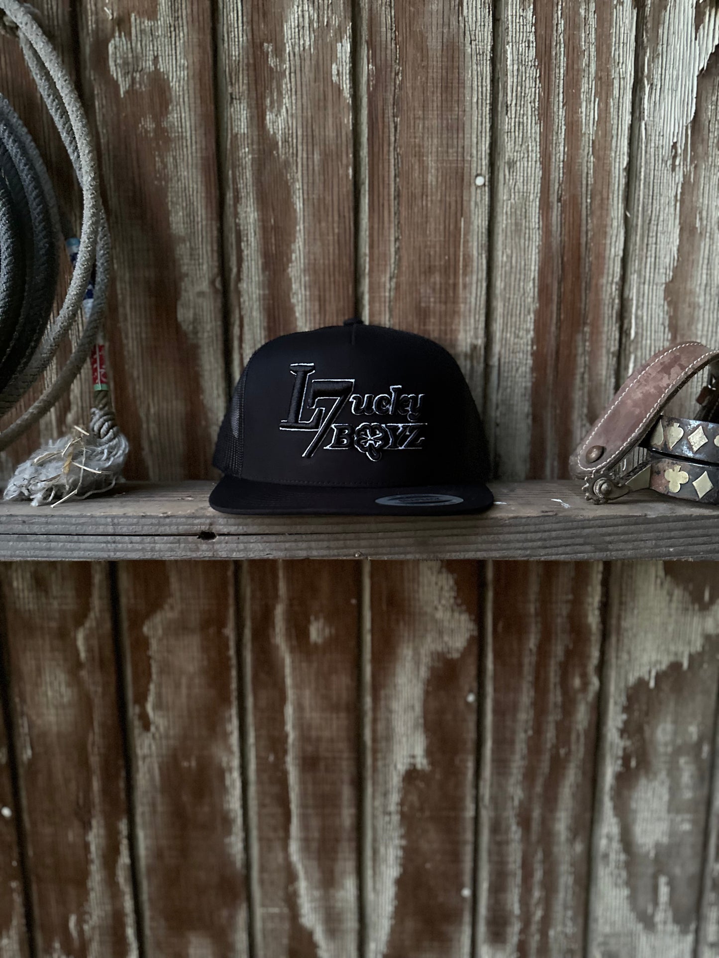 All black cap Lucky7 Boyz logo white outline