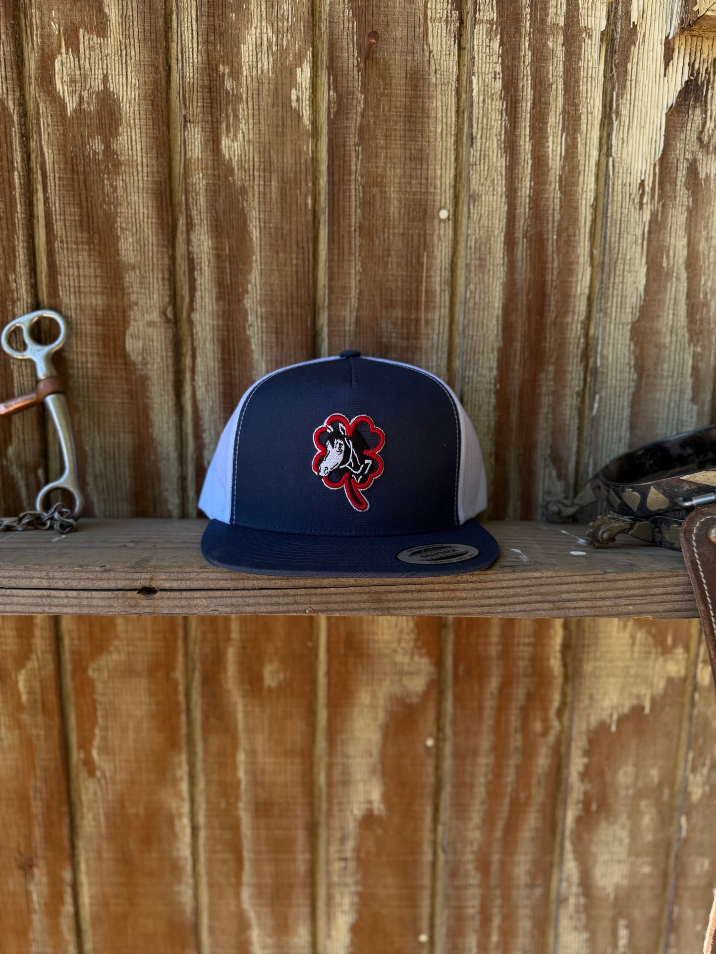 Navy blue hat horse logo red clover white outline